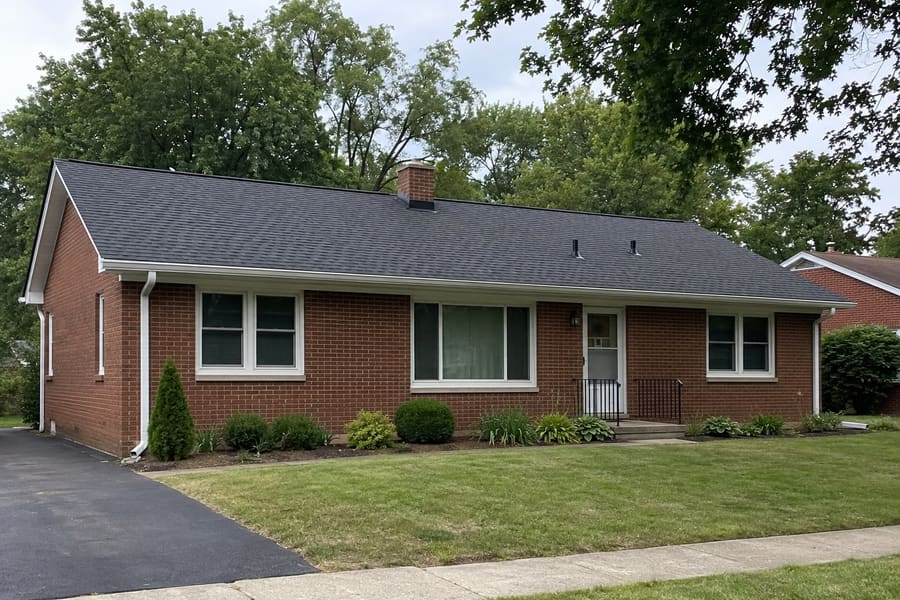 Single-story brick ranch with a dark gray architectural shingle roof